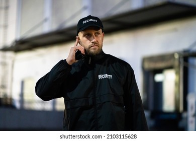Security Guard Standing In Front Of Building At Night