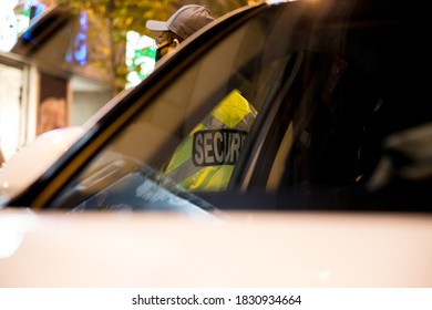 Security Guard Standing Next To Security Car At Night City