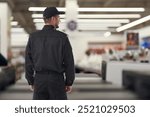 Security guard in supermarket, back view. Space for text