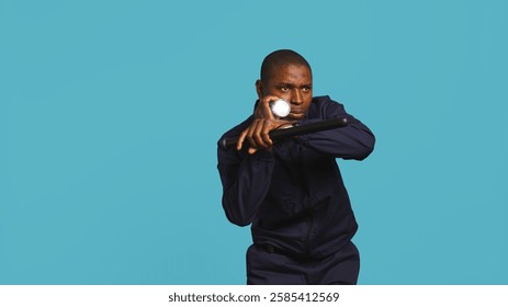 Security guard turning on flashlight and preparing baton to detect and detain suspects. Portrait of bodyguard using lantern and truncheon to subdue criminals, studio background, camera B