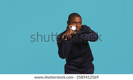 Security guard turning on flashlight and preparing baton to detect and detain suspects. Portrait of bodyguard using lantern and truncheon to subdue criminals, studio background, camera B
