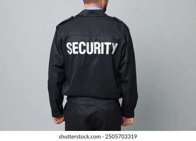 Security guard in uniform on grey background, closeup - Powered by Shutterstock