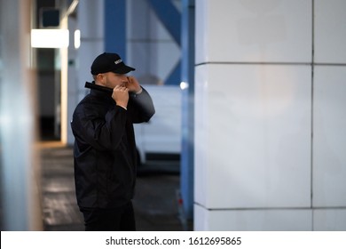 Security Guard Walking Building Perimeter With Flashlight At Night - Powered by Shutterstock