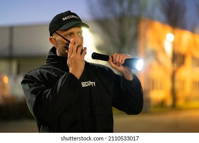 Security Guard Walking Outdoors With Flashlight At Night - Powered by Shutterstock