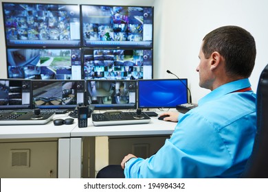 security guard watching video monitoring surveillance security system - Shutterstock ID 194984342