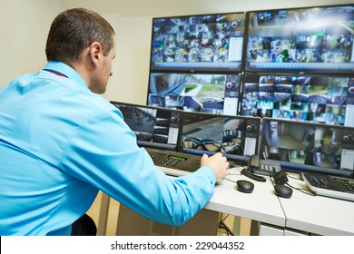 security guard watching video monitoring surveillance security system - Shutterstock ID 229044352