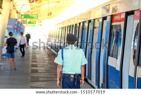 Security guards are currently standing orderly on the train station in Thailand.