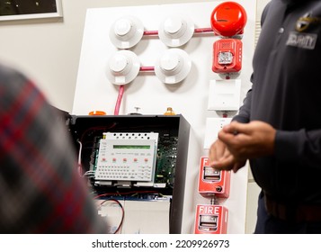 Security guards training how to use fire alarm and mock sprinkler system