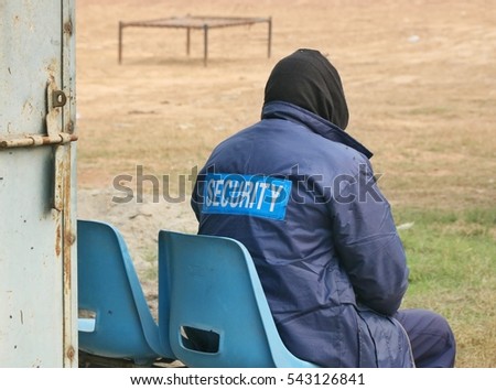 security gurad sit down outside and watching around area