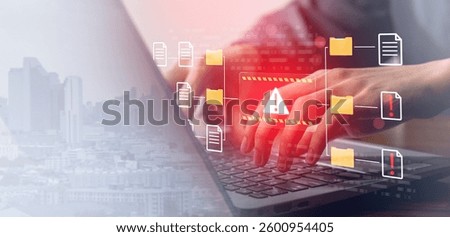 Security icon and notification of document system hacked. Hands typing on a keyboard with a red cybersecurity threat alert, surrounded by digital files and documents. 