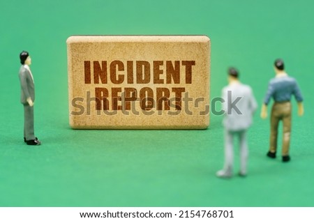 Security and insurance concept. On the green surface are figures of people and a sign with the inscription - Incident report