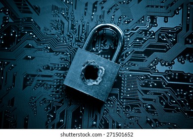 security lock with a hole on computer circuit board - computer security concept