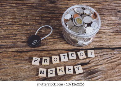 security lock with pass-code and full coins with jar, Words PROTECT MONEY made block wooden letters. Wood abc. Save Money Concept used for financial protection inferences or other investment messages