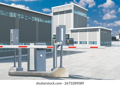 Security, Logistics, Industrial zone. Automatic barrier gate with access control system at entrance to modern warehouse and factory buildings under blue sky.
