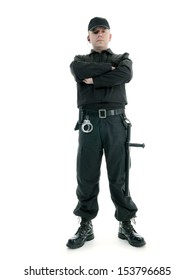 Security Man Wearing Black Uniform Equipped With Police Club And Handcuffs Standing Confidently With Arms Crossed, Shot On White