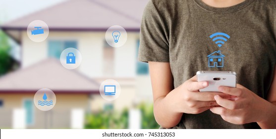 Security Mobile Control, The Internet Of Things, Woman Hand Using Smart Phone As Smart Home Wifi Remote App Over Blurred House Background, Banner, Smart Home Device Wireless Network