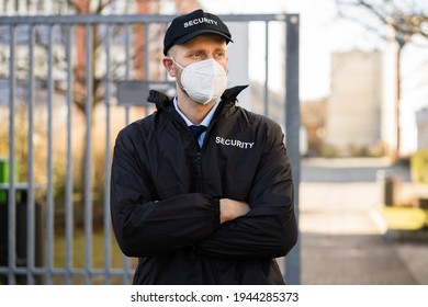 Security Officer In Covid Face Mask Outside Building