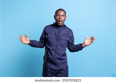 Security officer having a shocked reaction in front of the camera, being surprised after finding out something. African american public safety employee in uniform feels amazed in studio. - Powered by Shutterstock