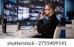 Security Officer Monitors Multiple CCTV Screens Intently At Surveillance Station
