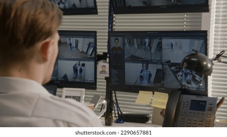 Security officer monitors office CCTV cameras on computers, uses walkie talkie. High tech software showing footage of surveillance cameras with facial recognition on screens. Concept of social safety. - Shutterstock ID 2290657881