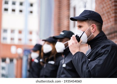 Security Officer Staff Group At Event In Face Mask