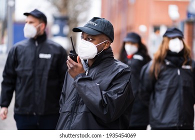 Security Officer Staff Group At Event In Face Mask