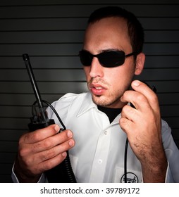 Security Patrol Officer Talking Into A Mobile Radio