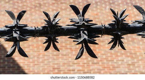 Security perimeter fence with sharp spikes. Anti wall climbing spinners with sharp barbs.