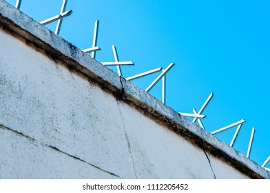 Security spikes on top of a wall.