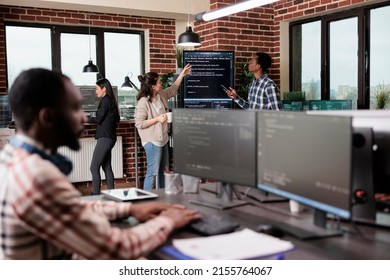 Security system developers analyzing application coding method in order to optimize data processing rate. Mixed race programmers team using machine learning to decypher encrypted stolen files.