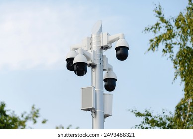 Security systems and alarm technology concept: Many CCTV cameras hanging on an outdoor pole and recording. Digital surveillance. High safety and protection cam and video.