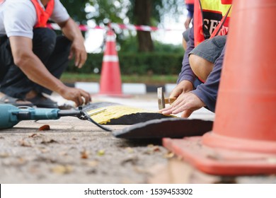 Security Team Installing Safety Road Speed Breaker Or Hump By Using Drill And Hammer