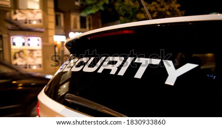 Security vehicle patrolling city at night