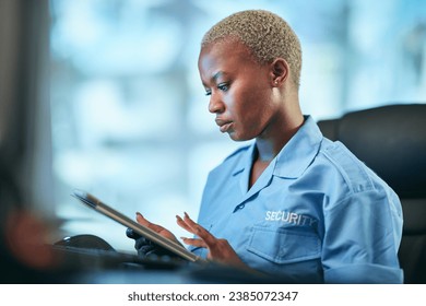 Security, working and black woman with tablet at a desk for communication, cctv app or building monitor. Digital, reading and an African safety officer typing on technology for a surveillance system - Powered by Shutterstock