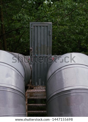 Secutiry door between two industrial pipes protects children from danger games