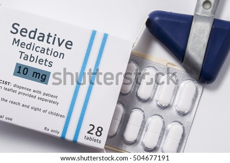 Sedative drug. Neurological reflex hammer and packaging box of medication with name group of drug Sedative with blister with pills on white background close up. Concept for treatment of irritability Foto d'archivio © 