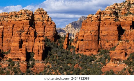 Sedona, Arizona's giant red rock mountains with desert bushes and plants in view, Yavapai and Coconino Counties, with Flagstaff, Cottonwood, Clarkdale, and Village of Oak Creek nearby, in March of 202 - Powered by Shutterstock