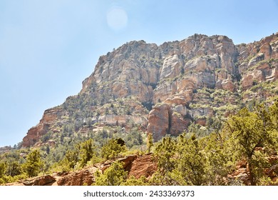 Sedona Red Rock Cliffs with Green Vegetation and Lens Flare - Powered by Shutterstock