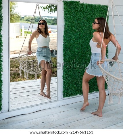 Similar – Young surfer woman with top and bikini kissing surfboard