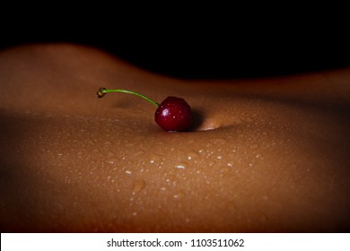 Seductive body. A young woman is eating cherries. Berries for an erotic evening. The girl lies on the bed before sex. Art for the body. Naked woman with a delicious berry. Food and body