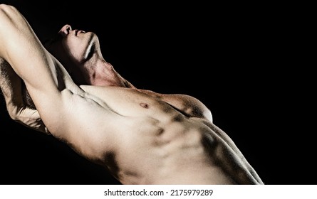 Seductive Gay. Muscular Body Of Man On Black Background. Strong Brutal Guy. Sexy Torso. Male Flexing His Muscles.