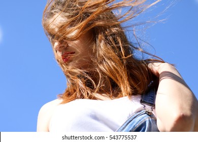 Seductive young woman on a windy day. wind blowing hair