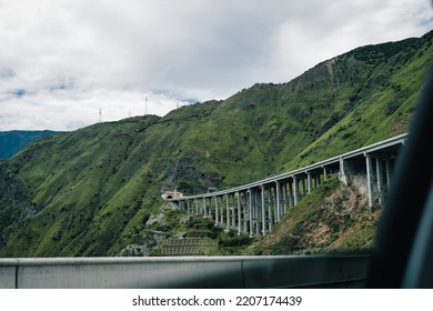 See The Bridge And Mountains Outside Through The Car Window