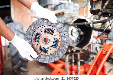 See details of clean old tractor clutch parts. Automobile clutch disc details, spare parts for repair, maintenance, tractor clutch disc, truck clutch disc. auto parts details - Shutterstock ID 2142637625