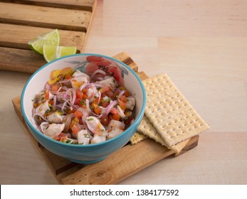 See Food Bowl of Ceviche with Onions Tomato and Parsley with a twist of Lime and Salt Crackers 