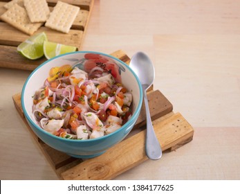 See Food Bowl of Ceviche with Onions Tomato and Parsley with a twist of Lime and Salt Crackers 