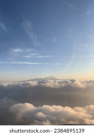 see the mountain upper the clouds and clear skies