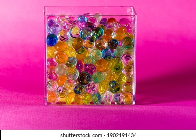 A See Through Glass Box Filled With Colorful Marbles