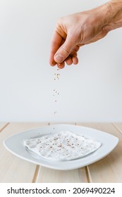 Seed Of Garden Cress Spread On White Plate With Wet Paper Towel In Front Of White Background