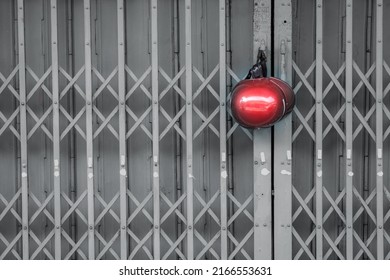 Seeing Red Helmet Hanging On Metal Door.